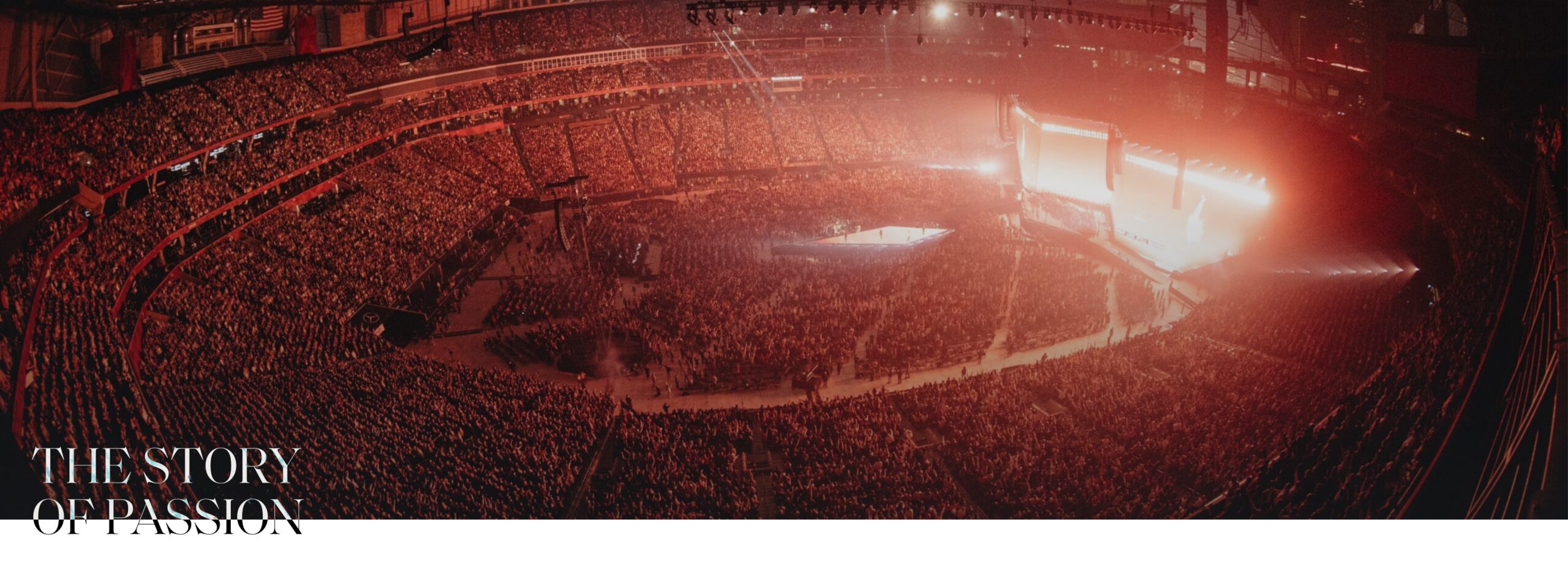 Large concert with stage lit in warm red on the right
